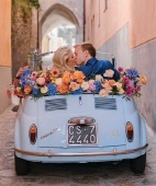 the happy couple leaving the Ravello ceremony in a baby blue Fiat. Photography by Kristen Kilpatrick